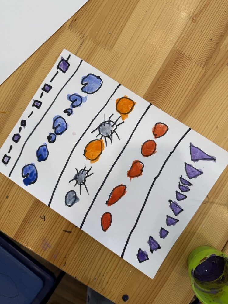 Rows of painted shapes in blue, orange and purple between ruled lines