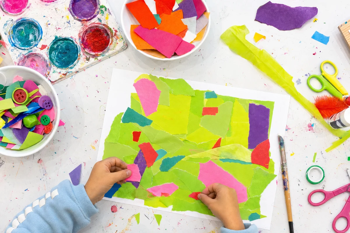 Torn paper shapes arranged and glued onto one big sheet